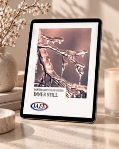 Tablet displaying JAFE's Winter 2027 color guide titled "Inner Still" featuring frost-covered branches, positioned on a marble surface with decorative elements