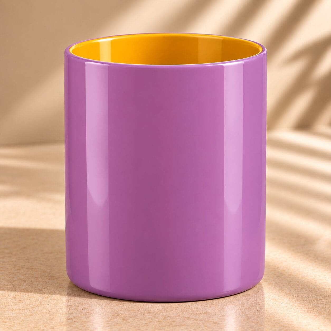 Purple cylindrical mug with yellow interior, displayed on beige surface with natural lighting and shadows