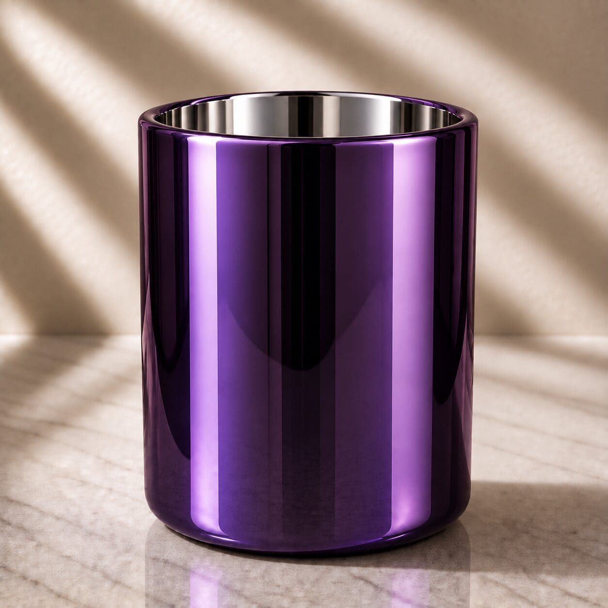 Purple metallic cylindrical container with stainless steel rim, sitting on marble surface with soft lighting and shadows