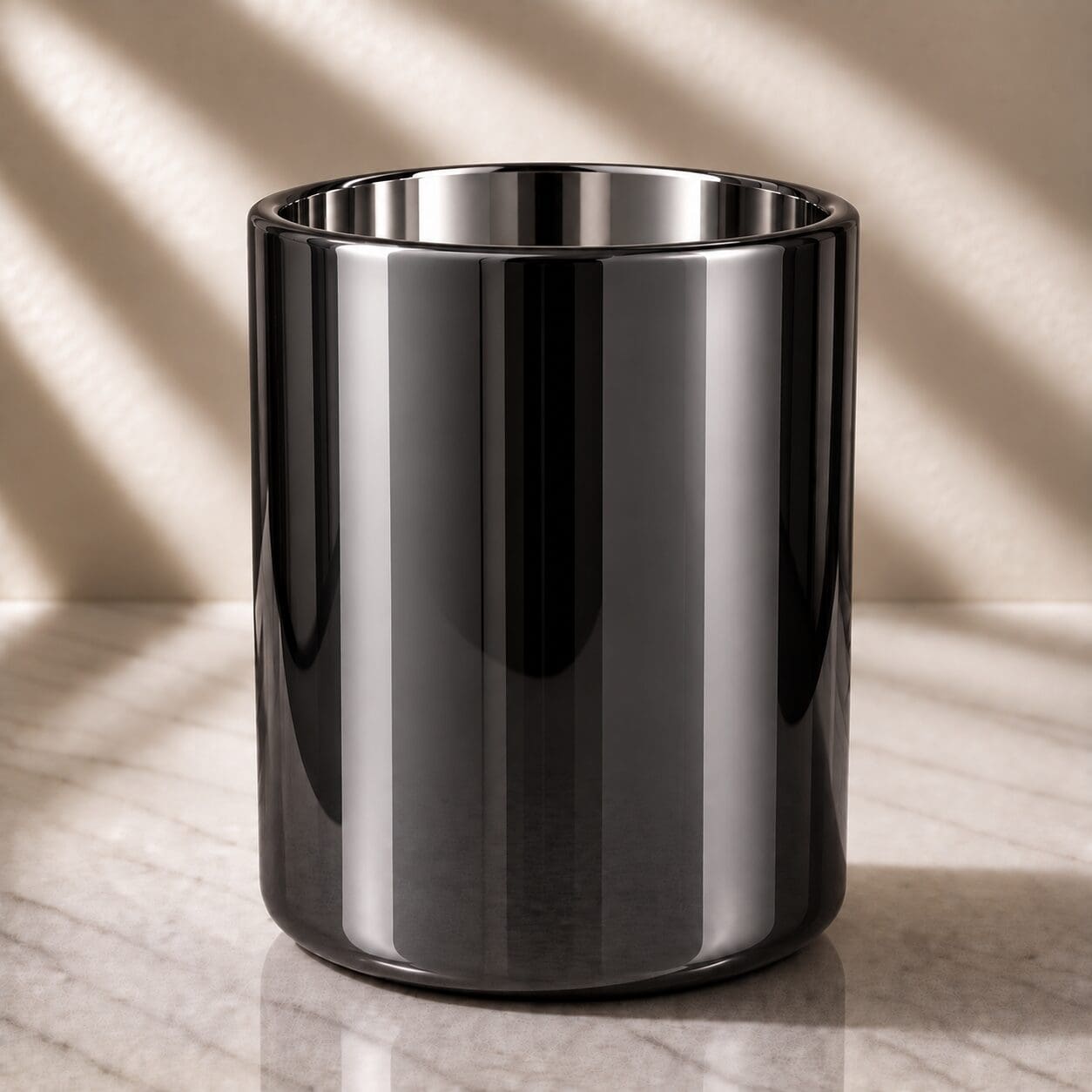 Polished stainless steel cylindrical container with reflective surface on marble floor with neutral lighting